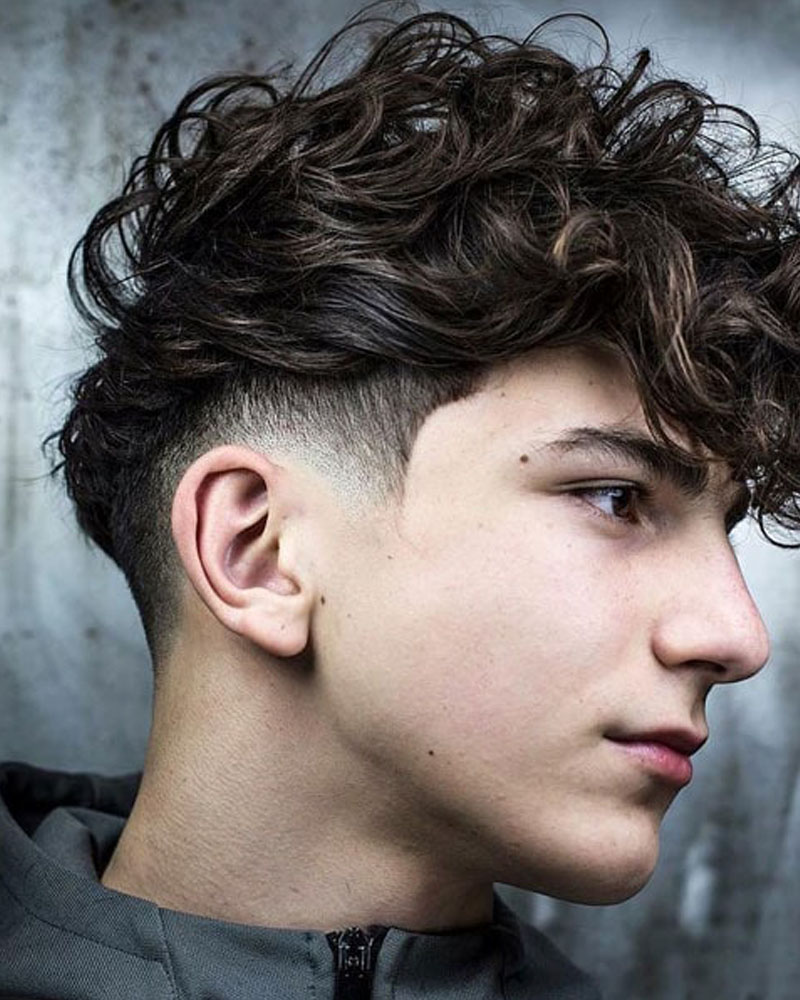 men fade haircuts low bald fade with curly fringe Luxe Digital