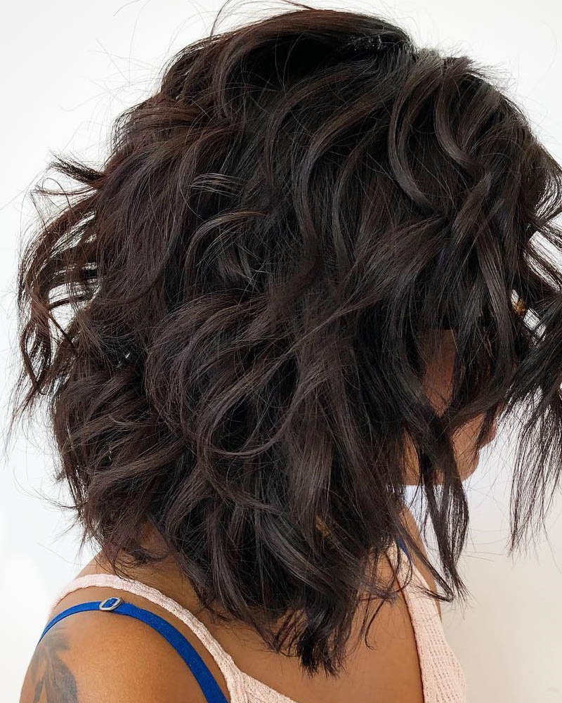 medium length hairstyles women choppy layered shoulder length curly hair Luxe Digital